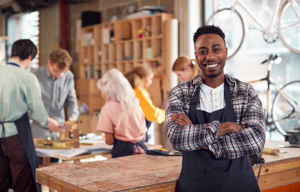 guy with arms crossed in a workshop